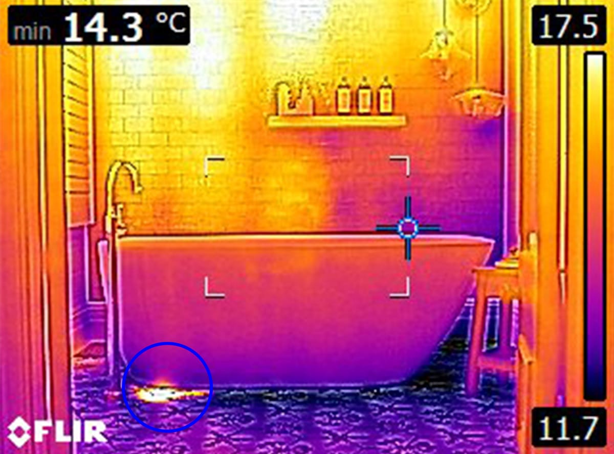 The same nice bathroom examined by a building inspector using a thermal camera to show the building issues that were previously invisible to the naked eye.